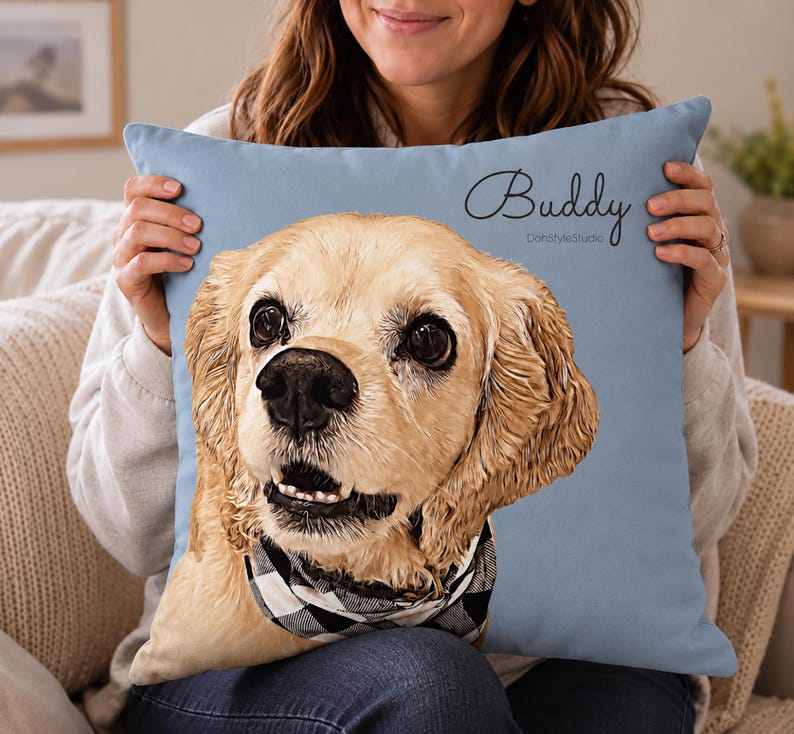 May include: A square light blue throw pillow featuring a detailed illustration of a golden-colored dog with floppy ears and a black and white checkered bandana. The name Buddy is printed in black script above the dog, with DohStyleStudio below.