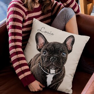 May include: A square throw pillow with a cream-colored background featuring a detailed illustration of a dark brindle French Bulldog with a white chest patch and a thin collar. The name Louie is printed in a cursive script above the dog's head.