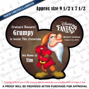 May include: A laminated cardstock sign in the shape of Mickey Mouse ears. The sign features the Disney character Grumpy, with text that reads "Cruisers Beware! Grumpy Is Inside This Stateroom." The sign is approximately 9.5 x 7.5 inches.