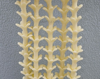 May include: Five vertical strands of cream-colored, flower-shaped beads arranged in a parallel pattern. Each strand features a repeating series of small, molded floral components stacked to create a continuous, textured, vine-like appearance.