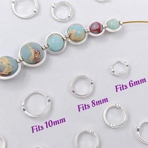 May include: Silver jump rings in various sizes, labelled with the bead size they fit: 6mm, 8mm, and 10mm. The rings are shown next to a strand of colourful beads.