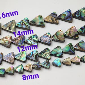 May include: A collection of triangular abalone shell beads arranged in four horizontal rows. The beads display iridescent green, blue, and purple hues. Text labels indicate sizes of 16mm, 14mm, 12mm, and 8mm next to each corresponding row of beads.