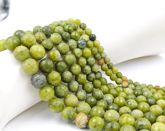 May include: A strand of green jade beads with a faceted finish. The beads are round and have a natural, earthy look.