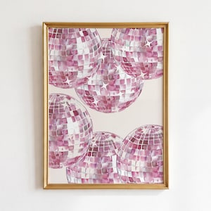May include: A framed wall art print featuring a watercolor illustration of multiple pink disco balls arranged in a cluster. Each spherical disco ball is composed of square mirrored facets in varying shades of pink and white, with star-shaped highlights.