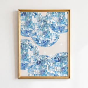 May include: A framed wall art print featuring a watercolour illustration of multiple blue disco balls arranged in a cluster. Each sphere is composed of square facets in varying shades of blue and white, accented with small white star-shaped highlights.