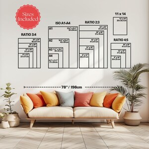 May include: A size guide chart displaying various print dimensions in inches and centimeters, categorized by ratios 3:4, ISO A1-A4, 2:3, 11x14, and 4:5. The chart is positioned above a light-colored sofa with orange, yellow, and gray pillows.