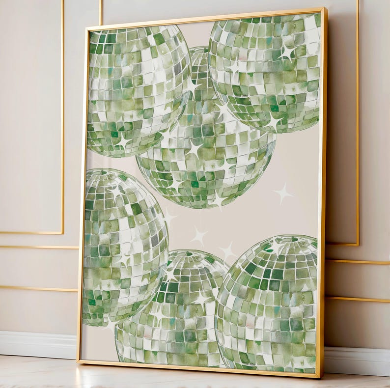 May include: A framed art print featuring several green disco balls with a mosaic tile design. The disco balls are set against a neutral background with scattered white star shapes. The frame is gold.