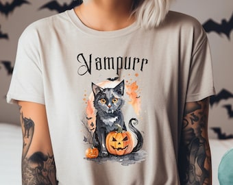 May include: A gray t-shirt with a black cat and a jack-o-lantern. The cat has fangs and the text "Vampurr" is printed on the shirt.