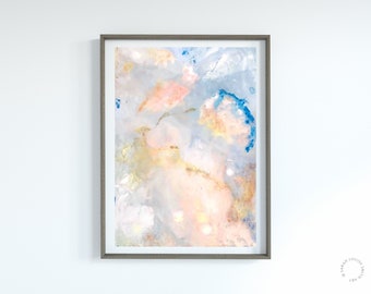 May include: Abstract painting in shades of blue, pink, and gold. The painting is framed in a light brown frame.