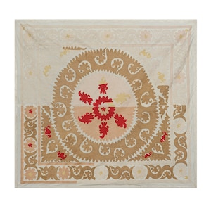 May include: A white cotton textile with a central design of a red and pink flower surrounded by a brown floral pattern. The textile has a border of brown floral designs.