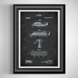 May include: Framed black and white patent print of a harmonica, featuring detailed diagrams and technical drawings. The print includes the patent number 692,520 and the date of patent, Nov. 28, 1911. The artwork is set against a dark background.