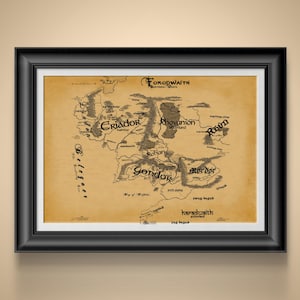 May include: Framed map of Middle-earth, featuring locations like Gondor, Mordor, and Rohan, in a vintage style. The map is printed on aged paper and encased in a black frame, suitable for home decor.