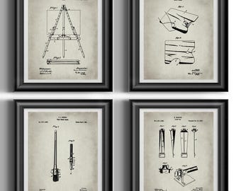 May include: A set of four framed wall art prints featuring vintage black and white technical patent illustrations on a beige background. The prints display detailed line drawings of an easel, a tool, a brush, and a mechanical device with text.