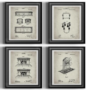 May include: Set of four vintage patent prints featuring black and white illustrations of different types of tombstones and grave markers. The prints are framed in black frames and have a light grey background.