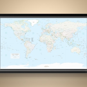 May include: A framed world map with a light blue background and detailed country outlines. The map is labeled "Countries of the World" and is encased in a black frame. The map shows continents, oceans, and country names.