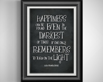 May include: Black and white typography quote on a chalkboard background. The quote reads "Happiness can be found even in the darkest of times if one only remembers to turn on the light." The quote is attributed to Albus Dumbledore.