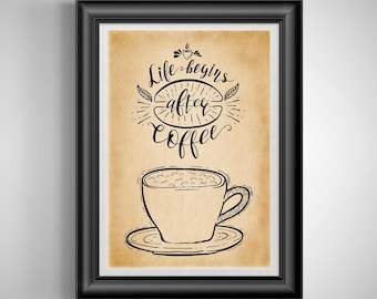 May include: Black framed art print with the text "Life begins after coffee" in a decorative font. The print features a coffee cup illustration with a saucer, all in black ink on a tan background.