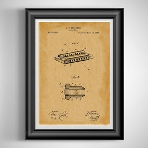 May include: Framed vintage patent print of a harmonica, dated March 18, 1890. The sepia-toned print features detailed technical drawings and text, including the inventor's name, J.F. Stratton, and patent number 588,920. The print is in a black frame.