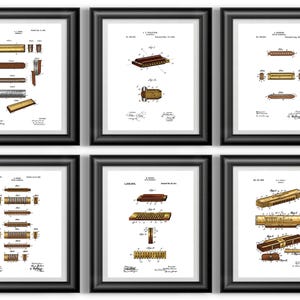May include: Six framed patent prints of harmonicas in various designs. Each print features detailed technical drawings in brown and gold tones against a white background. The frames are black, creating a classic presentation for music-themed decor.