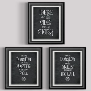 May include: Three framed prints with black frames and white matting. Each print has a black background with white text. The top print reads "THERE ARE SIDES TO EVERY STORY." The bottom left print reads "THIS IS MY DUNGEON I AM THE MASTER & THIS IS HOW I ROLL." The bottom right print reads "WHEN THE DUNGEON MASTER SMILES IT'S ALREADY TOO LATE."