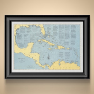 May include: Framed vintage treasure map of the Gulf of Mexico and the West Indies, featuring a detailed nautical chart with blue and yellow hues. The map is encased in a black frame, suitable for nautical decor.