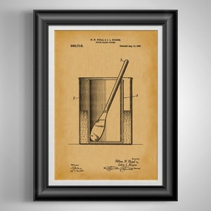 May include: Framed patent print of a butter making process, featuring a diagram of a container with a spoon. The print has a sepia tone, with text including the patent number and inventor names. The frame is black.