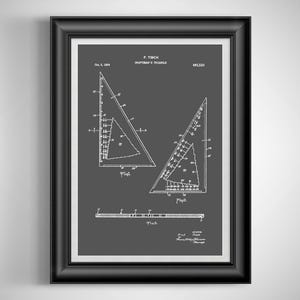 May include: Framed print of a draftsman's triangle patent illustration. The print features white line drawings on a dark gray background, with the title "DRAFTSMAN'S TRIANGLE" and the name "F. TISCH". The frame is black.