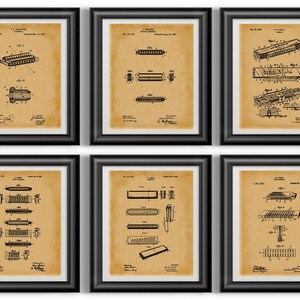 May include: Six framed vintage harmonica patent prints. Each print features detailed black and white diagrams on a tan background, encased in a black frame. The prints showcase various harmonica designs and technical drawings.