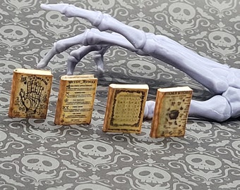May include: Four miniature books with aged paper covers and black text. The books are titled "Palm is in the Hand", "Witch Runes", "Ancient Witchcraft", and "Modern Witchcraft".
