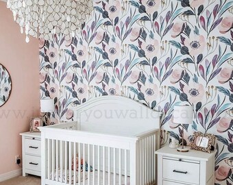May include: A white crib with a floral patterned wallpaper behind it. The wallpaper features pink, purple, and blue flowers on a white background. There are two white nightstands with drawers on either side of the crib.