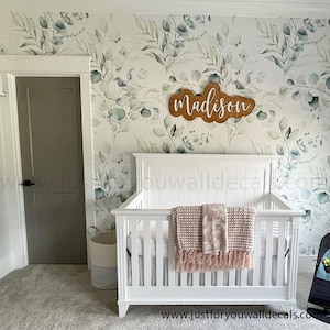 Soothing wallpaper design featuring watercolor eucalyptus branches in gentle shades of green