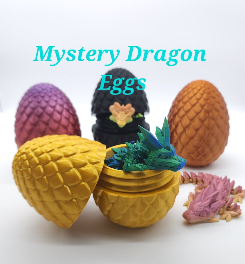 May include: A collection of 3D-printed dragon eggs in various colors, including purple, black, and gold. One egg is open, revealing a small, blue and green dragon. The text "Mystery Dragon Eggs" is displayed in turquoise.