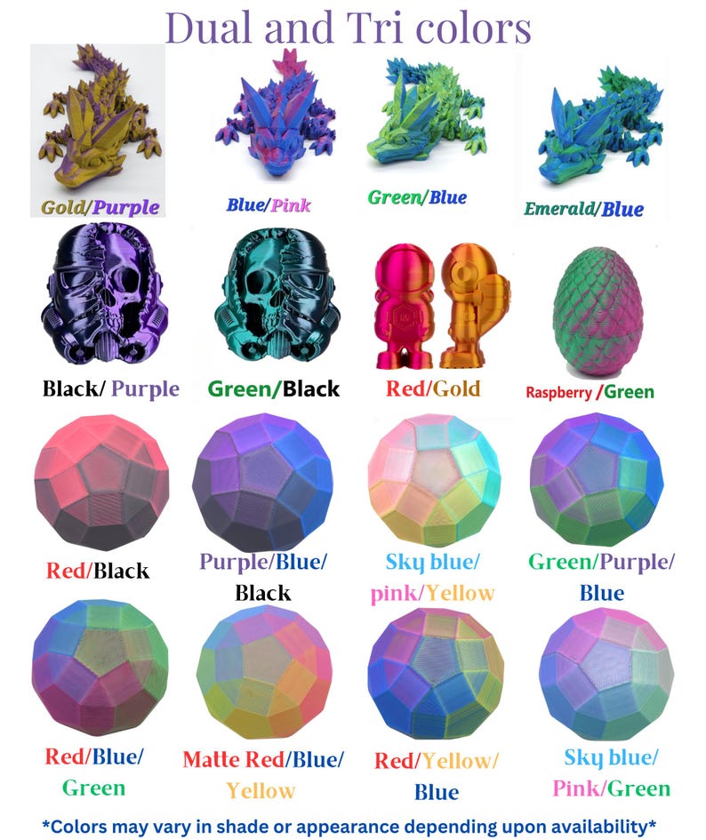 May include: A display of 3D-printed items in dual and tri-colour schemes. The image features dragon figurines, skull-shaped figures, small robot-like figures, and geometric spheres. Colours include gold/purple, blue/pink, green/blue, and red/black.