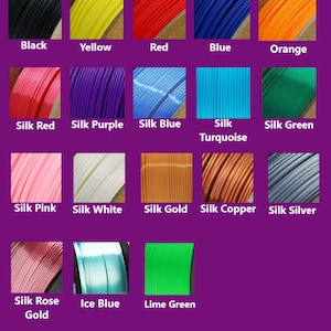 May include: A colour chart showing a range of filament colours. These include black, yellow, red, blue, and orange, alongside silk red, purple, blue, turquoise, and green. Also shown are silk pink, white, gold, copper, and silver, plus silk rose gold, ice blue, and lime green.