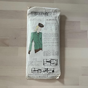 May include: A vintage Bestway Pattern B.20,767 for a jacket. The envelope shows a drawing of a woman in a green jacket, brown gloves, and a hat. The envelope is aged and shows signs of wear and tear.
