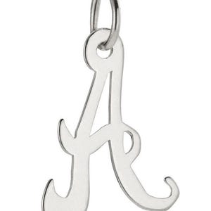 May include: A silver-coloured pendant in the shape of the letter "A" in a cursive font. The pendant has a loop at the top for attaching to a chain or bracelet. The letter is smooth and shiny, with rounded edges.
