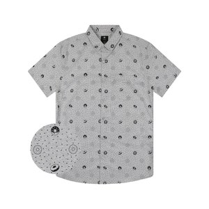 May include: A gray short-sleeved button-down shirt with a black donut pattern. The shirt has a pocket on the left side.