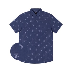 May include: Navy blue short-sleeve button-down shirt with a white fishing-themed pattern. The shirt features a button-down collar, a chest pocket, and a small logo near the top button. The fishing pattern includes boats, fish, and fishing rods.