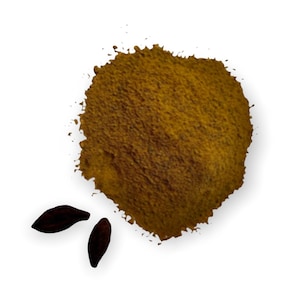 May include: A pile of brown ground spice with two small black seeds.