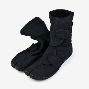 May include: Black tabi boots with a split toe design. These boots have a high-top style with adjustable hook-and-loop straps for a secure fit. The soles are textured for grip, and the boots are made of a durable fabric.