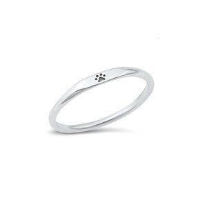 May include: A silver ring with a small paw print design.