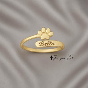 Anillo ajustable con huella de pata en oro macizo de 10K, 14K o 18K (amarillo, rosa o blanco). Graba la fecha o el nombre de tu mascota.