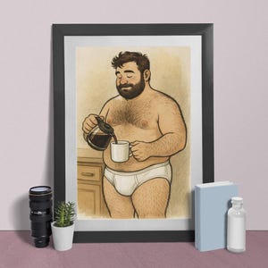 May include: Framed art print depicting a cartoon illustration of a man pouring coffee into a mug. The man is wearing white briefs. The artwork is displayed on a pink surface with a camera lens, a small plant, a book, and a bottle.