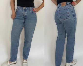 May include: A pair of blue denim jeans with a straight leg fit. The jeans have a classic five-pocket design and a button fly.