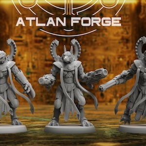 May include: Three gray miniature figurines of humanoid creatures with elaborate headgear and weaponry. The figures stand on circular bases, with the text "ATLAN FORGE" above them. The background is a blurred, golden-toned scene.