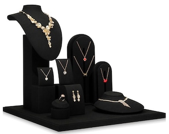 May include: Black velvet jewelry display stand with multiple tiers and a mannequin bust for necklaces. The stand features various sized compartments for rings, earrings, and necklaces.