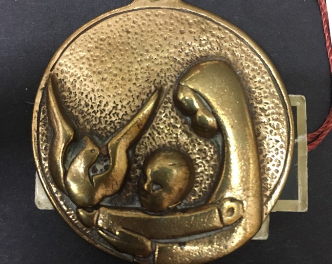 Religious bronze art, Virgin with Child medal and dove of peace.