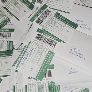 May include: A collection of white envelopes and U.S. Postal Service Certified Mail receipts with green accents, barcodes, and tracking numbers. Several envelopes feature handwritten addresses to a P.O. Box in Allen, Texas, 75013.