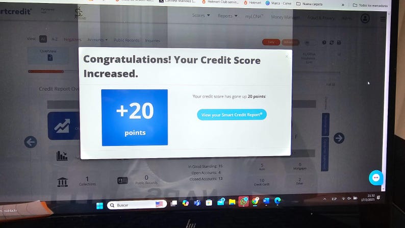 May include: A laptop screen shows a credit report with a pop-up message. The message reads "Congratulations! Your Credit Score Increased." A blue box shows "+20 points." The screen also has navigation icons and text related to credit reports.