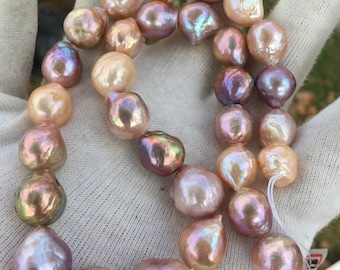 May include: A strand of large, baroque pearls in shades of pink, peach, and lavender. The pearls have an iridescent sheen and are strung on a white thread.
